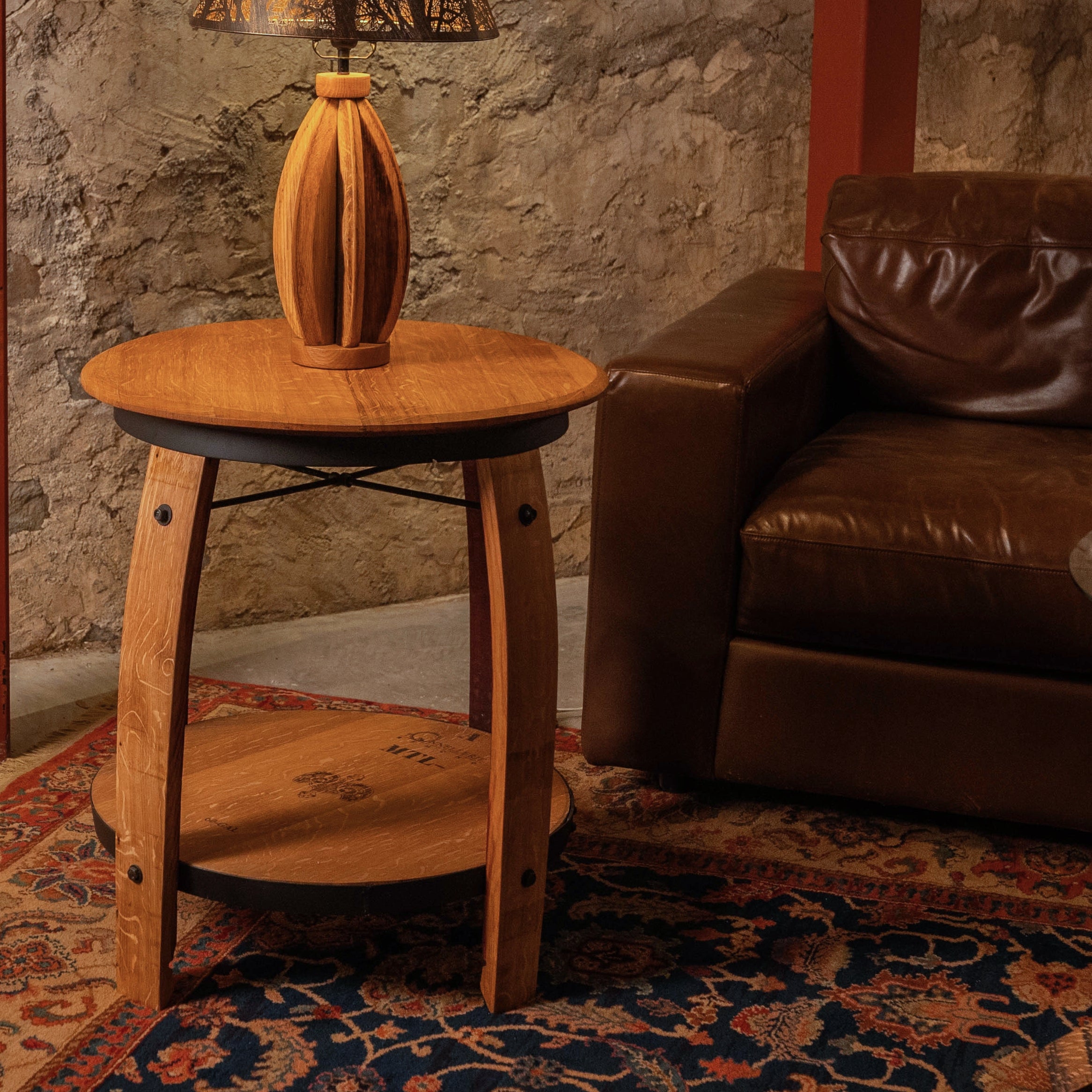 Casq Wine Barrel End Table in a living room setting, featuring a round reclaimed barrelhead top, lower shelf, and curved oak staves as legs.