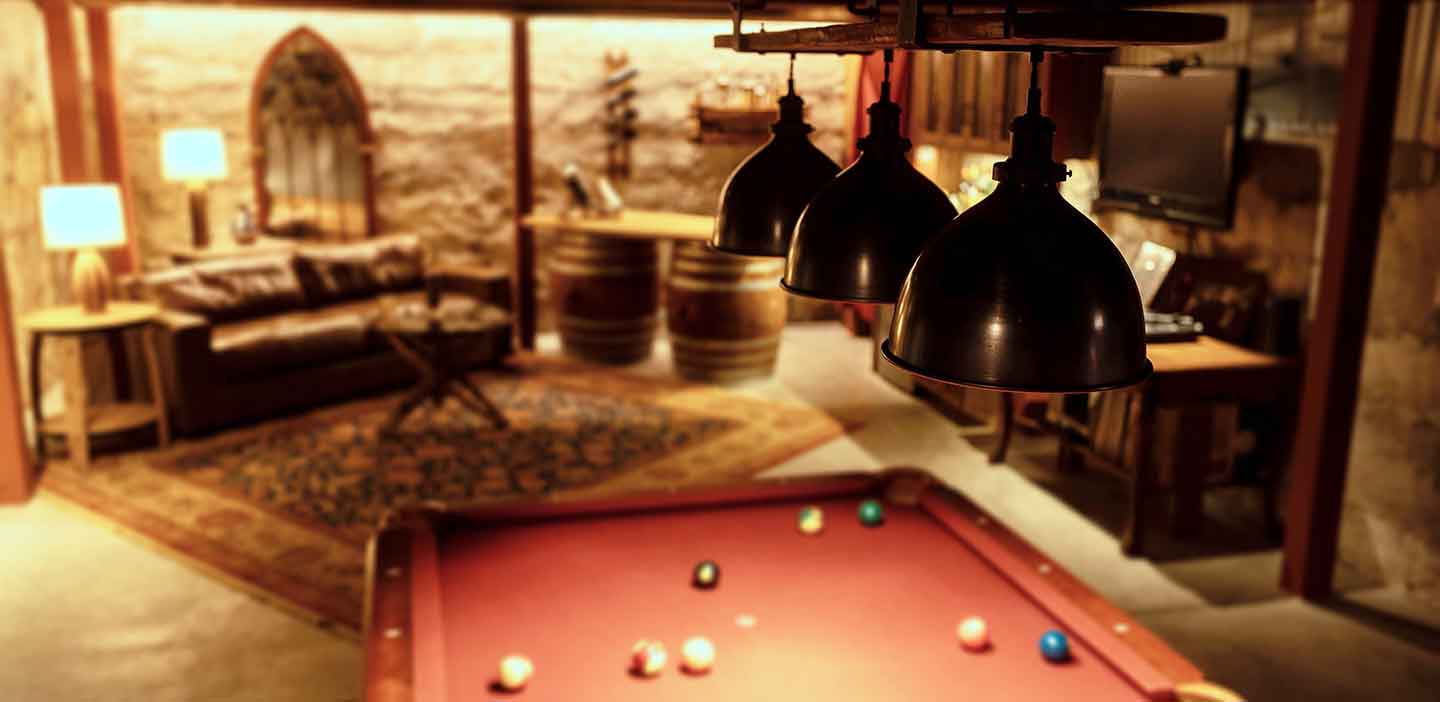 Rustic lighting shown over a Pool Table with Table Lights in the background, part of a home bar scene.