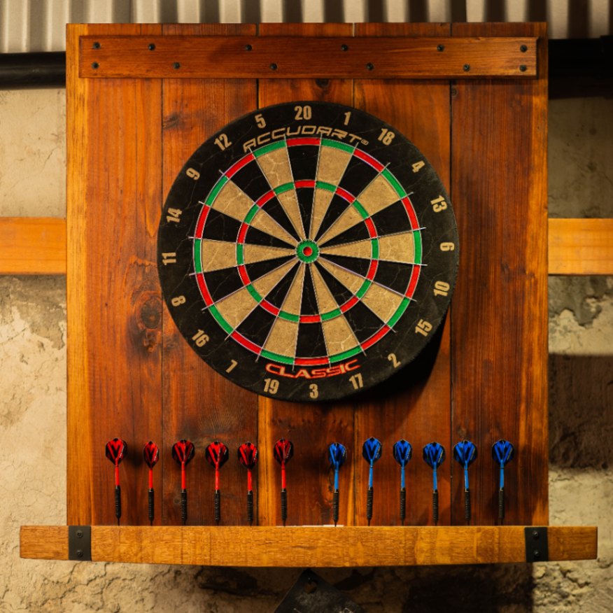 Reclaimed-wood dart backboard with mounted dartboard and 12 darts stored below.