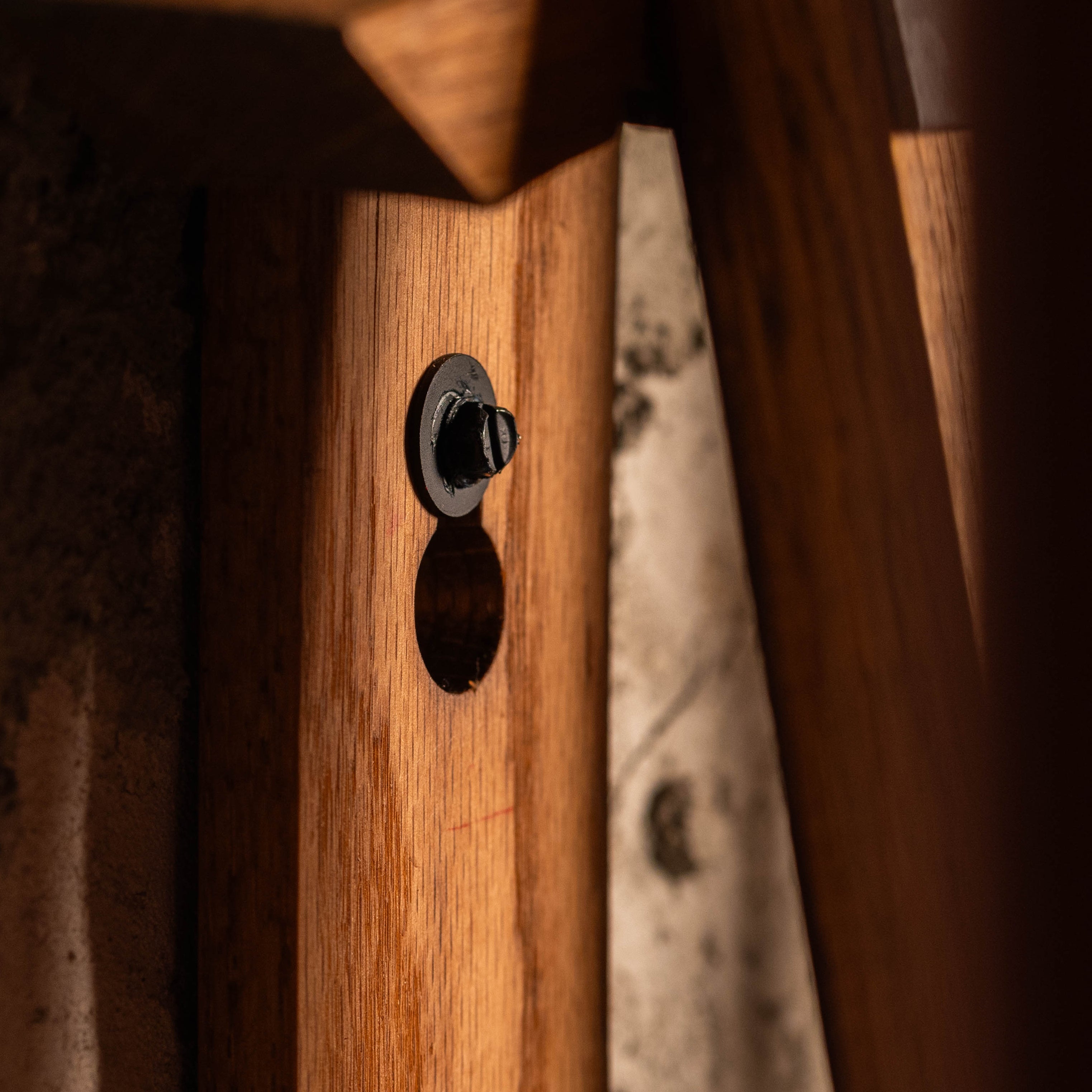 Detail shot of through-bolt mounting and barrel stave construction on cue rack