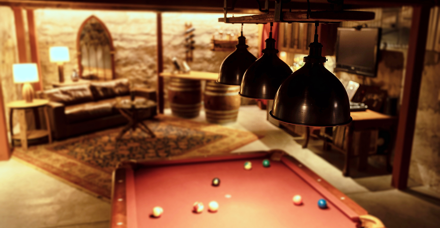 Rustic lighting shown over a Pool Table with Table Lights in the background, part of a home bar scene.