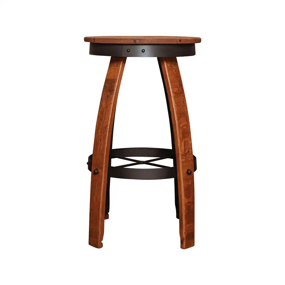 Close-up of a rustic bar stool handcrafted from reclaimed wine barrel staves, featuring a round wooden seat, black metal hoop, and subtle industrial accents against a stone cellar wall.