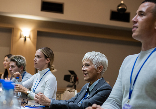 Group of people at a sustainability conference discussing climate and environmental impact.